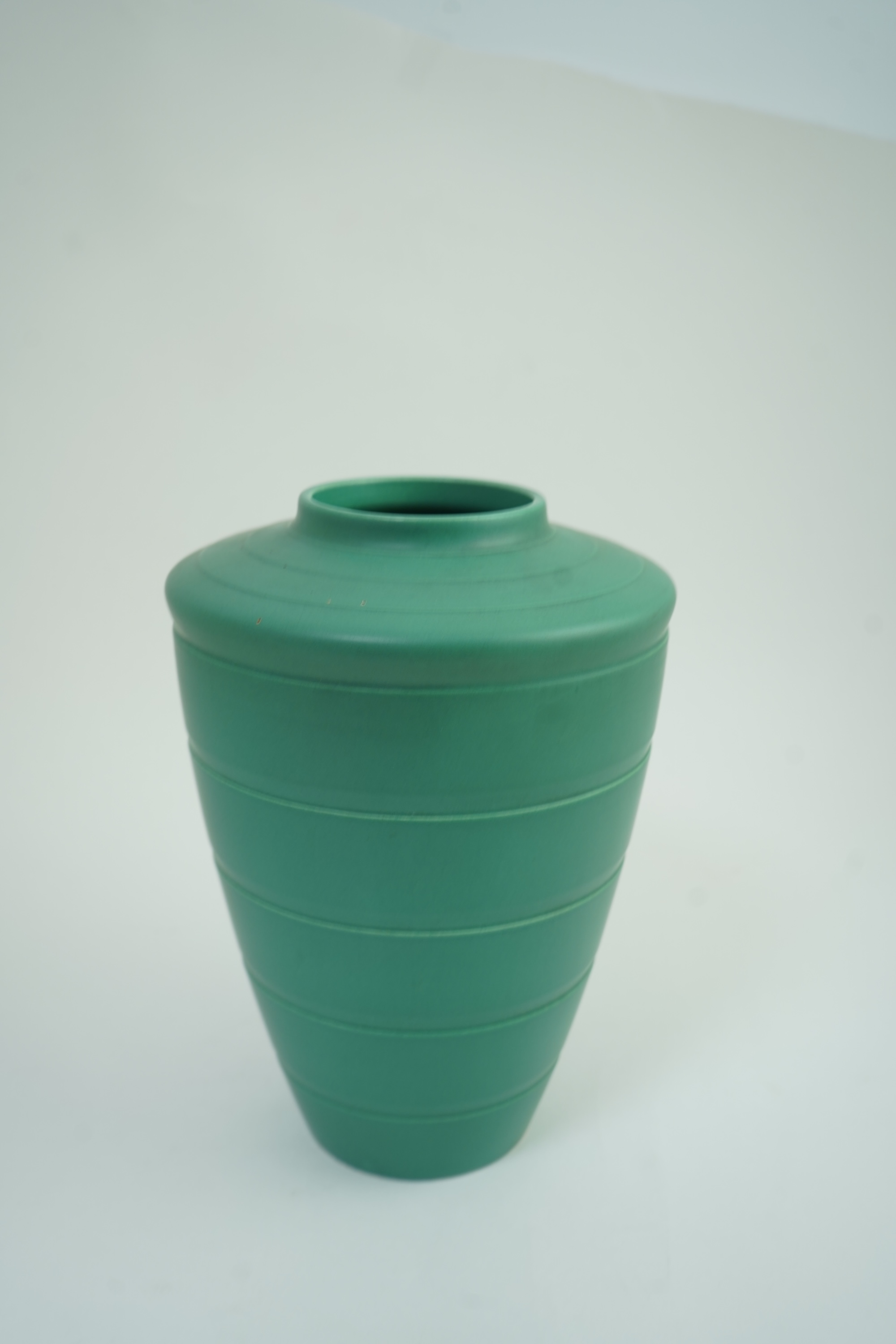Keith Murray MC RDI FRIBA (New Zealand/British, 1892-1981) for Wedgwood: A matt green glazed tapering vase